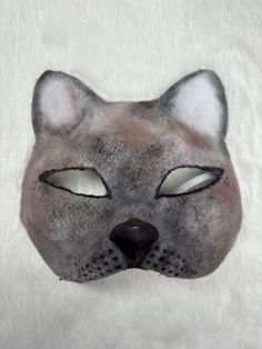 This is one of my newer masks, a siamese cat! It is a high quality mask made from a cat mask base.  Mask Features: * Designed with eyeshadow for an airbrushed look * Clay nose add on * Felted Note: This product is made with a paper base, and therefore will mold if it gets wet and not dried properly. Please be careful not to bring this product near water! If you have any questions, feel free to reach out! Cat Ears Masks With Whiskers For Masquerade, Cat Design Eye Mask For Costume Party, Cat Design Eye Mask For Masquerade, Masquerade Cat Ears Mask With Whiskers, Masquerade Eye Mask With Cat Design, Cat Design Eye Mask For Costume, Cat Design Costume Eye Mask, Costume Cat Design Eye Mask, Masquerade Mask With Whiskers