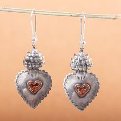 Maria Belen Nilson finds inspiration in Mexican vintage artistry for the lovely design of these earrings. The heart earrings are crafted by hand with sterling silver featuring an antiqued finish that underscores bright copper hearts at the center. .925 Sterling silver Silver Bohemian Heart Earrings For Valentine's Day, Silver Bohemian Earrings For Valentine's Day, Silver Heart-shaped Copper Jewelry, Heart-shaped Silver Copper Jewelry, Vintage Silver Heart Earrings For Valentine's Day, Silver Vintage Heart Earrings For Valentine's Day, Vintage Sterling Silver Pierced Heart Earrings, Vintage Style Sterling Silver Pierced Heart Earrings, Vintage Silver Heart Earrings For Anniversary