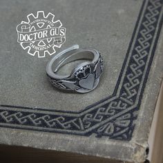 Here is a fantastic Doctor Gus original ring. This ring features a Claddagh design. Wear this ring to make a statement everyday. Or get one to add that perfect final touch to your next renaissance costume. Each one is unique and sure to start a conversation! This ring is a Doctor Gus original! That means I sculpted it myself by hand. Then I cast and finish each and every one right here in my Pennsylvania workshop. Every single ring I make is 100% handcrafted in the USA! ------------------------- Symbolic Adjustable Engraved Nickel-free Ring, Symbolic Adjustable Nickel-free Engraved Ring, Adjustable Nickel-free Symbolic Engraved Ring, Antique Silver Metal Rings As Gift, Themed Silver Ring Jewelry, Symbolic Engraved Metal Ring For Gift, Vintage Engraved Metal Ring As Gift, Vintage Engraved Metal Ring For Gifts, Vintage Metal Engraved Ring For Gift