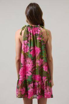 Bring the Dandi Floral Rumba Halter Mini Dress to your next vacation. An extra cute pink floral print designs this mini dress with a ruffle trim high neckline with a halter style. Adjust the height slightly with adjustable tie strings. The dress maintains an A line silhouette with a ruffle tier hem. Wear it with pink strappy heels. - Adjustable straps- Shift silhouette- Halter neck- Lined- Color: Green Pink CoralSize + Fit - Model is 5'8" and wearing size XS- Measurements taken from size S - Che Pink Strappy Heels, Line Silhouette, Floral Print Design, Cap Sleeve Top, Pink Floral Print, Halter Mini Dress, Tiered Maxi Dress, 80 Dress, Halter Style