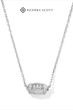 As stunning as it is spirited, the Tiny Diamond Football 14k White Gold Pendant Necklace in White Diamond is ready to get in the game. An heirloom-quality 14k gold football is striped with dainty white diamonds for an all-star level of shine. Paired with a jersey or fancy fit, you’ll win every game day wearing this elevated pendant. We have taken steps to ensure that, when applicable, our diamonds are conflict free by requiring our suppliers to comply with the Kimberley Process. Dainty Jewelry Necklace, White Gold Pendant Necklace, Engagement Rings Sale, Bar Jewelry, Sports Jewelry, Kendra Scott Jewelry, Tiny Diamond, Initial Jewelry, Demi Fine Jewelry