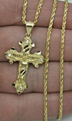 "This stunning pendant is made of genuine 10k yellow gold and features a beautifully crafted Jesus Christ Crucifix Cross design. The pendant is adorned with sparkling cubic zirconia stones that have been diamond cut for maximum brilliance. It comes with a matching chain, making it the perfect gift for a loved one or a special addition to your own jewelry collection. DETAILS: Style                      Jesus Crucifix Cross Metal                     10K Solid Gold  Metal Purity           10K STAMP Gold Jewelry Men, Yellow Diamond Earring, Dope Jewelry Accessories, Expensive Jewelry Luxury, Chain Making, Mens Jewelry Necklace, Jesus Christus, Dope Jewelry, Jewelry Fashion Trends