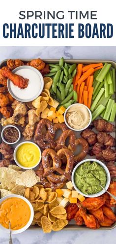 a tray filled with different types of food and dipping sauces on top of it