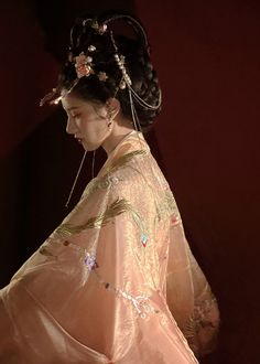 For the summer goddess, this gorgeous Tang Dynasty inspired set is adorned head to toe with embroideries of peonies, phoenixes and feathers. Not one corner is neglected! From the wrists to the back, envelop yourself in the luxuries of high quality flowers. The Daxiushan (大袖衫, wide sleeved jacket) is dramatic and elegant, creating movement and grace with its exaggerated sleeves. Layer the embroidered jacket over the sheer jacket for a dimensional effect. The star of the show is the Heziqun (诃子裙, Wedding Kimono With Floral Embroidery, Traditional Spring Kimono, Traditional Spring Wedding Kimono, Spring Wedding Kimono With Floral Embroidery, Spring Wedding Embroidered Kimono, Traditional Pink Kimono For Wedding, Traditional Pink Wedding Kimono, Pink Bohemian Kimono For Wedding, Bohemian Pink Kimono For Wedding