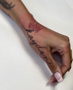 a person's hand with a tattoo that says, king and queen on it