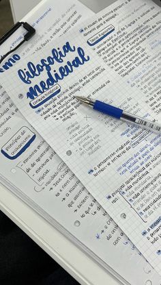 a pen sitting on top of an open notebook