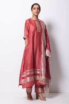 Brick pink kurta highlighted with zardozi embroidery, round neckline and straight silhouette. Comes with cotton silk pant, chanderi dupatta and inner slip.
Component: 4
Pattern: Embroidered
Type Of Work: Zardozi
Neckline: Round
Sleeve Type: Three Quarter
Fabric: Kurta: Handwoven Chanderi Silk; Dupatta: Chanderi; Pant: Cotton Silk
Color: Pink
Other Details: 
Straight kurta
Concealed placket
Side pockets
Asymmetric hem
Contrast hem pant
Dupatta with tassels
Occasion: Mehendi and Haldi, Puja - Aza Chanderi Silk Suit Designs Indian, Straight Kurti Designs, Chanderi Silk Suits, Silk Kurta Set, Shirt Patterns, Silk Kurti Designs, Kurti Style, Chanderi Dupatta, Pink Kurta