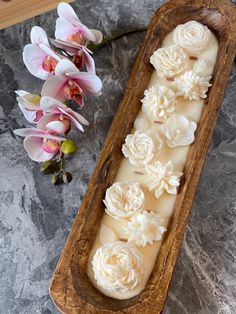 some flowers are sitting in a wooden bowl