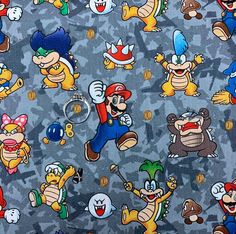 the fabric has many different cartoon characters all over it, including mario and other characters