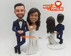 the bride and groom are holding each other's hand in front of their wedding cake toppers