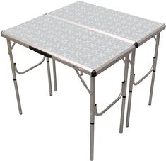 the folding table is white and has flowers on it, as well as two legs