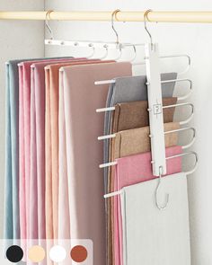 a rack with clothes hanging on it in front of a white wall and several color swatches