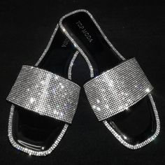 Sparkle In These Blingy Open Toe Wide Band Slides New In Box Man Made Material Clear Silver Rhinestones Lightly Padded Insole Comfy Flat Heel Fitting: True To Size. Regular Foot Width Silver Crystal Sandals, Silver Rhinestone Evening Sandals, Silver Sandals With Rhinestones For Party, Silver Bedazzled Sandals For Evening, Silver Crystal Sandals For Party, Silver Crystal Sandals For Evening, Silver Embellished Sandals For Night Out, Silver Bedazzled Party Sandals, Silver Bling Sandals For Night Out