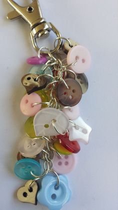 a bunch of different colored buttons attached to a key chain