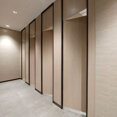 an empty room with wooden partitions and tile flooring