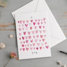 two cards with pink hearts on them, one has the words i love you written in it