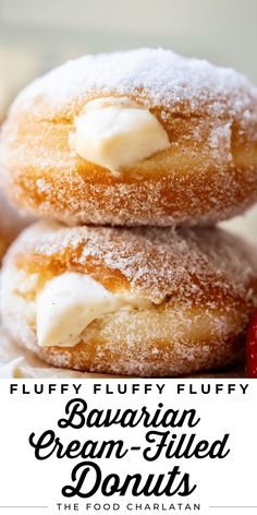 two sugar filled doughnuts on top of each other with icing and strawberries in the background