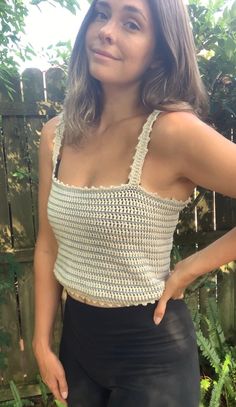 a woman is wearing a crocheted crop top