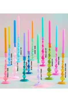 there are many different colored candles on the table and one is labeled with names for each candle