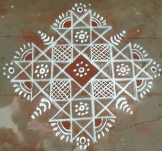 an intricately designed design on the ground with white paint and dots in the center