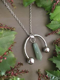 Introducing 'ROGUE' Handmade Aventurine Pendant Necklace on a stainless steel chain. This one-of-a-kind necklace features a captivating aventurine stone that is renowned for its properties of opportunity, optimism, and luck. Crafted with care, this pendant necklace showcases a bold and daring design that sets it apart from the rest. The beautiful green hue of the aventurine stone adds a touch of natural beauty to your ensemble. With its stainless steel chain, this necklace is durable and long-la Jewellery Minimalist, Healing Stones Jewelry, Aventurine Crystal, Hamsa Pendant, Stone Jewellery, Aventurine Stone, Crystal Pendant Necklace, Necklace Green, Crystal Necklace Pendant