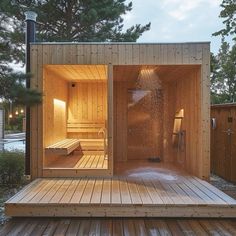 an outdoor sauna with wooden decking and benches