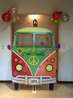 a vw bus with peace painted on it's side and balloons around the back