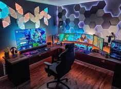 a gaming room with multiple monitors and games on the wall