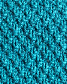 close up view of the crochet stitchs on an afghan blanket in blue