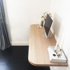 a wooden desk with two candles on it