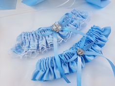 "Blue Garter, Wedding Garter Blue, Garter Set, Blue Bridal Garter, Wedding Garter Set, Blue Garter Set, Garters For Wedding, Garter Belt Beautiful wedding set! Made of ice blue satin, light blue ribbons and bows, white lace and beautiful brooches. * Base color can be changed to White instead of ice blue as on picture (specifically white satin fabric). To request the base color change, just mention it in the \"note to seller\" box at the checkout. Please, choose your accessories in a drop down me Blue Garter Wedding, Garters For Wedding, Blue Bridal Garter, Bridal Garter Blue, White Satin Fabric, Wedding Garter Blue, Light Blue Ribbon, Garter Wedding, Blue Garter