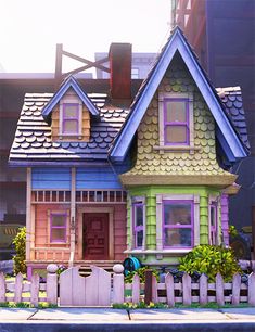 a colorful house with a picket fence in front of it