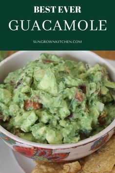 guacamole in a bowl with tortilla chips on the side