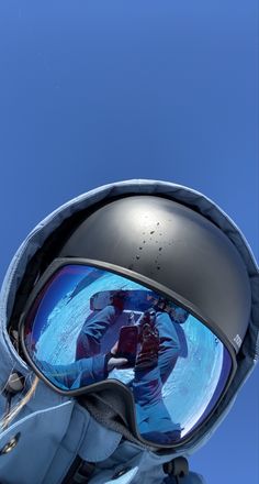 the reflection of a skier in his goggles