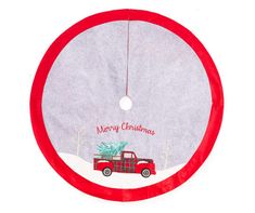 a red truck with a christmas tree on it's back hanging from a circular ornament