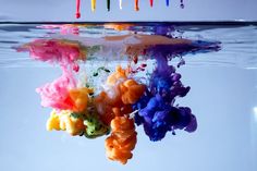 the colors of paint are being mixed in with water and on top of each other