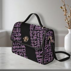 Elevate your style with our Classic Black Shoulder Bag, featuring an eye-catching purple pattern. Made of high-grade tarpaulin, this durable and stylish bag measures 10.63" (L) x 4.13" (W) x 7.87" (H), making it the perfect accessory for any occasion. Product Details: Material: High-grade tarpaulin - durable waterproof canvas . Design: Black edging, black handles, and shoulder straps secured with khaki stitching. Versatility: Use it as an iPad storage bag, business briefcase, college bag, leisur Purple Shoulder Bag With Notable Handles, Purple Rectangular Bag With Top Carry Handle, Purple Rectangular Bags With Adjustable Handle, Chic Purple Shoulder Bag With Zipper Closure, Functional Purple Shoulder Bag With Zipper Closure, Ipad Storage, Hand Bags For Women, Business Briefcase, Travel Handbags