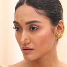 Description This elegant nose pin from Tarinika- antique collection features a floral motif inspired by the traditional Indian patterns. It has semi-precious stones on an antique gold base that add a touch of sparkle. This nose pin can complement any ethnic or fusion outfit, especially solid colors. Wear it with your favorite saree or kurta for a stunning look. Details & Specifications: Materials used: Brass Alloy with Oxidized Silver Plating Weight - Nose Pin-.1.85 gm Length - Nose Pin-1.5 cm M Nose Pins For Bride, Bridal Nose Pin Design, Nose Pin South Indian, Traditional Indian Patterns, Antique Nose Pin, Oxidized Nose Pin, Nose Pin Indian, Carnatic Music, Nose Pin