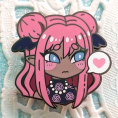 a close up of a cartoon character on a white surface with blue eyes and pink hair