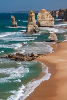 the beach is lined with large rock formations