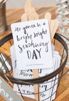 a basket filled with lots of wooden sticks next to a sign that says it's going