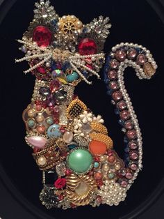 a cat made out of beads and other items