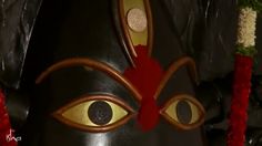 a close up of a mask with an evil look on it's face and eyes