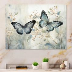 two blue butterflies flying over flowers on a white marble wall above a fireplace mantel