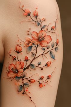 the back of a woman's shoulder with flowers and leaves painted on her body