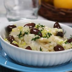 a white bowl filled with food on top of a blue plate