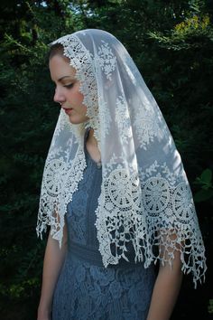 "Evintage Veils~ In an incredibly intricate, beautiful embroidered lace, this soft, ivory veil is of heirloom quality. A medium length mantilla, it provides excellent coverage, and it is soft and comfortable. Measures about 50 X 23 inches. In a long size, here: https://www.etsy.com/listing/1056055539/evintage-veils-mater-dei-heirloom-wrap?ref=shop_home_active_1 Also in an infinity veil here: https://www.etsy.com/listing/960466585/evintage-veilsready-to-ship-mater-dei?ref=shop_home_active_41& Cream Embroidered Lace For Ceremony, Ceremony Embroidered Cream Lace, Victorian Lace For Wedding, Cream Lace Veil With Lace Work, Vintage Lace With Lace Trim For Ceremony, Vintage Embroidered Lace For Wedding, Cream Bohemian Lace With Lace Trim, Bohemian Cream Lace With Lace Trim, Bohemian Beige Crochet Lace