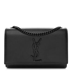 This is an authentic SAINT LAURENT Grain De Poudre Small Monogram Monochrome Kate Satchel in Black. This ultra-stylish shoulder bag is finely crafted of grained calfskin leather in black. The bag features a black bijoux waist-length shoulder strap and a crossover flap with a matching black YSL logo. The flap opens to a black fabric interior with a patch pocket. Ysl Satchel Bag, Ysl Kate Monogram Bag, Quilted Toys, Kate Bags, Ysl Logo, Vanity Bag, College Bags, Stylish Shoulder Bag, Saint Laurent Bag