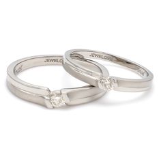 Platinum Love Bands by Jewelove This pair has matte finish majorly with hi-polish on the sides. Each of the rings has a single diamond. Women's band details : Platinum purity : 95% Platinum stamp : Pt950 Platinum certificate : Platinum Guild International Diamond count : 1 Diamond weight : 0.09 cts. Diamond clarity : VS Diamond color : J Diamond setting : Embedded Setting Diamond Grading Report : SGL Men's band details : Platinum purity : 95% Platinum stamp : Pt950 Platinum certificate : Platinu Modern Couple Rings With Diamond Cut For Promise, Classic Round Cut Diamond Couple Rings, Formal Diamond Solitaire Couple Rings, Couple Rings With Diamond Accents For Promise, Formal Solitaire Diamond Couple Rings, Modern Channel Set Wedding Rings, Couple Promise Rings With Diamond Accents, Formal Couple Rings Diamond Cut In Diamond White, Modern Brilliant Cut Rings For Promise