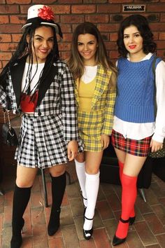 three women dressed up in costumes posing for the camera